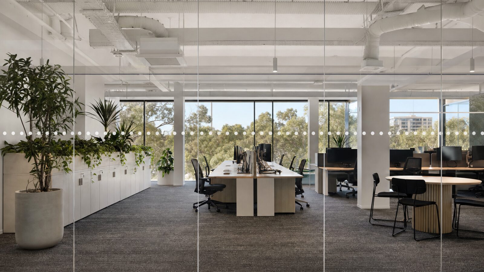 Full-height office glass wall with manifestation dot pattern at eye height