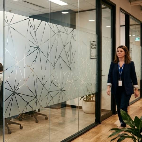 Meeting room glass with a fine geometric line pattern that veils the interior