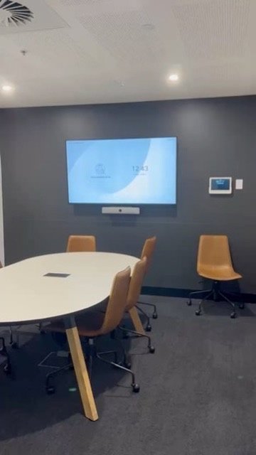 Boardroom with charcoal feature wall and integrated AV display