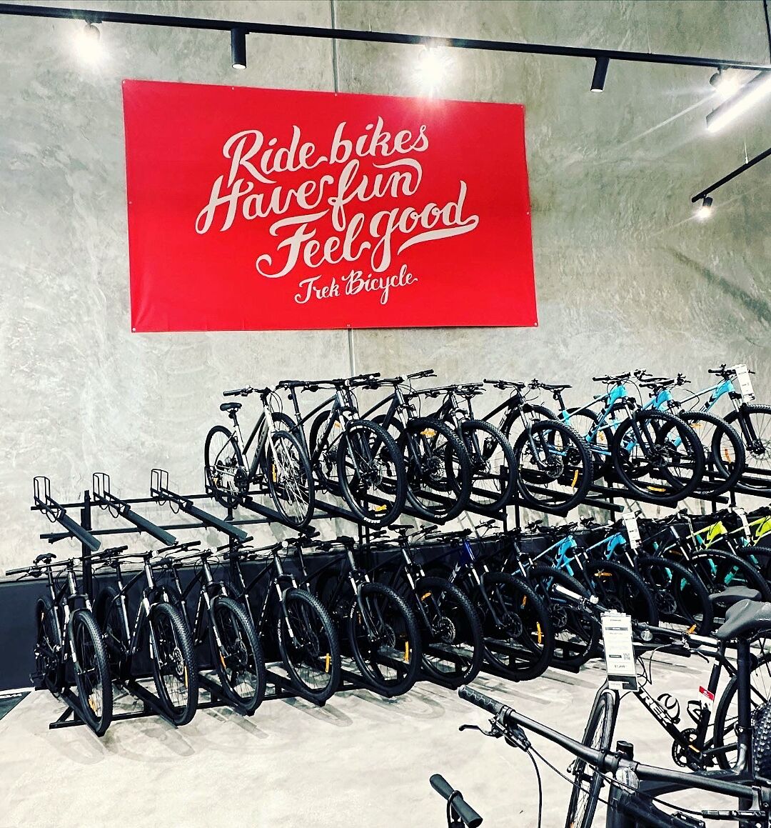 Trek Bicycle showroom with bold red 'Ride Bikes' interior banner